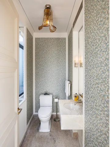 a bathroom with a granite countertop sink a toilet and a mirror