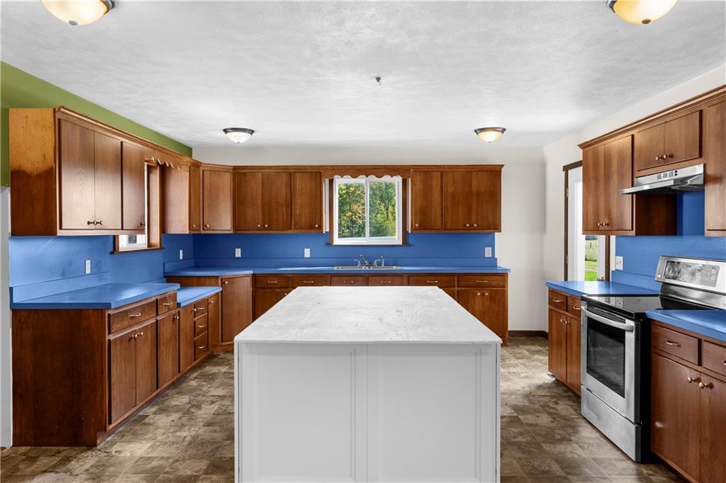 409 Bower Road Fredonia, PA 16124 - Photo 21 of 48 a kitchen with stainless steel appliances granite countertop a sink a stove and a wooden floors