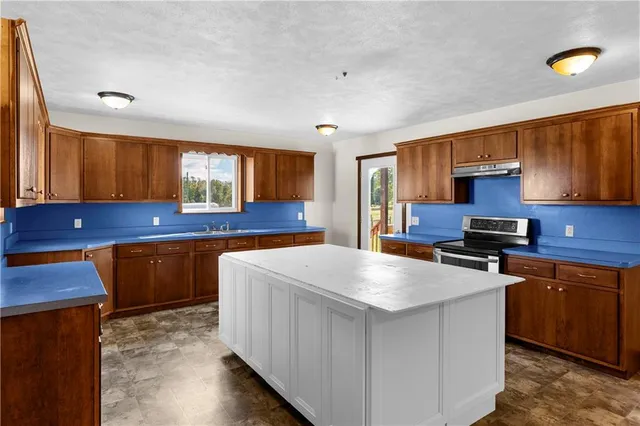 a kitchen that has a sink and a wooden floor