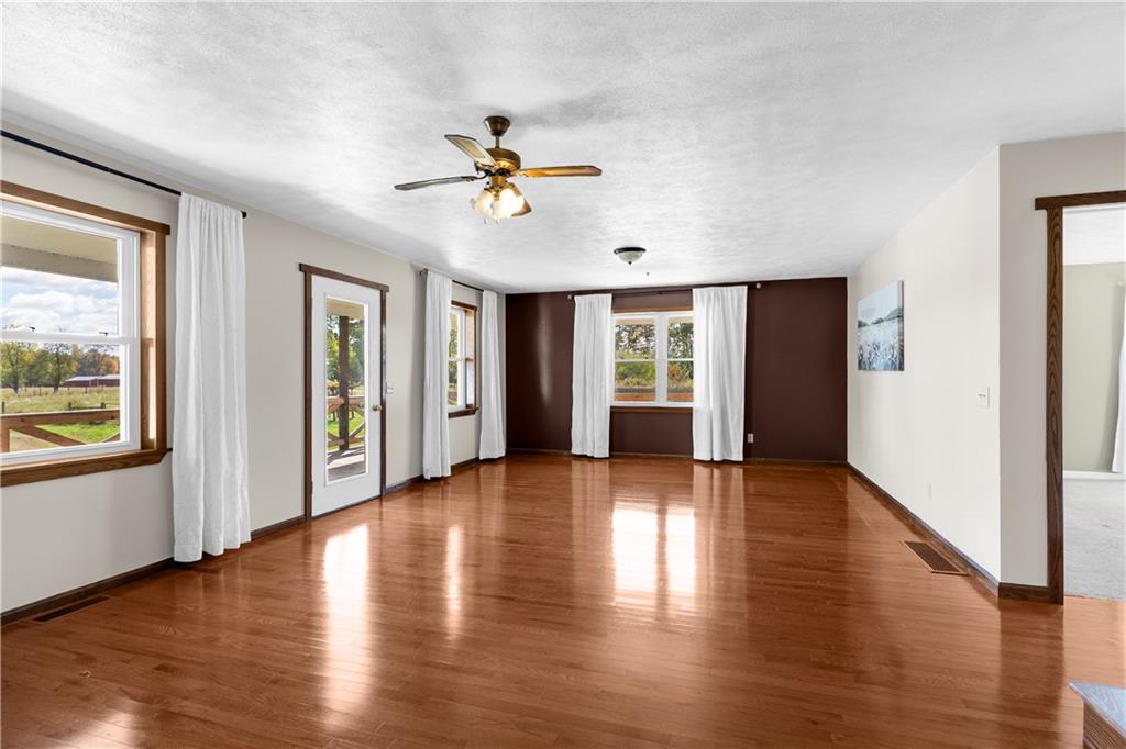 409 Bower Road Fredonia, PA 16124 - Photo 26 of 48 a view of an empty room with window and wooden floor