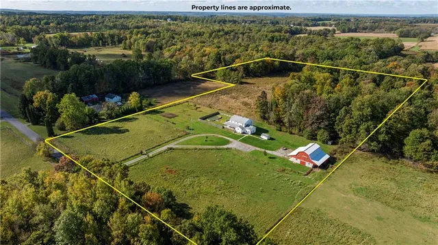 an aerial view of a residential houses with yard