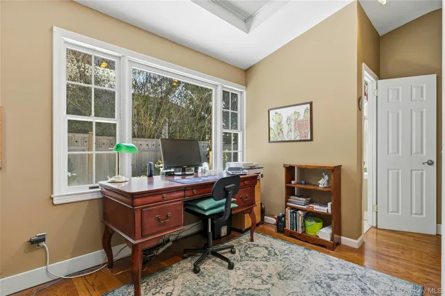 a bedroom with a bed and dresser with mirror