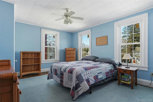 a living room with a bed furniture and decor