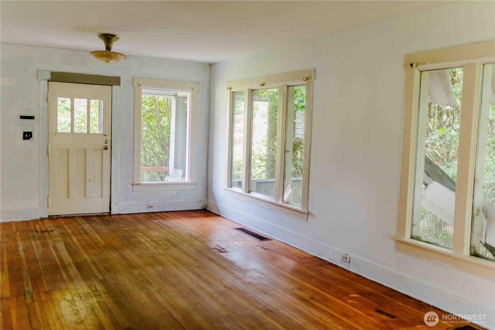 565 South Director Street Seattle, WA 98108 - Photo 27 of 34 a view of an empty room with a window and wooden floor