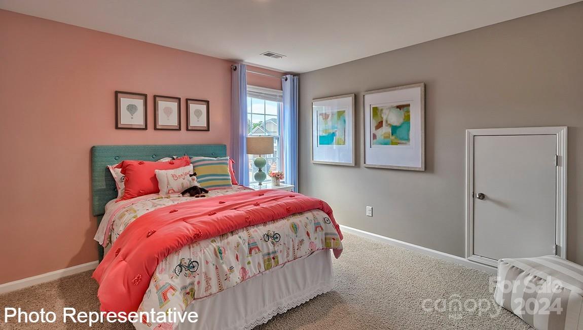 113 Dandelion Road Fletcher, NC 28732 - Photo 27 of 29 a bedroom with a bed and painting on the wall