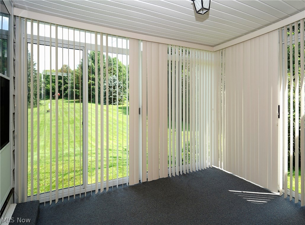14077 Alexander Road Bedford, OH 44146 - Photo 20 of 31 Two walls of sliding glass doors. Vinyl paneled ceiling. Outdoor carpet.