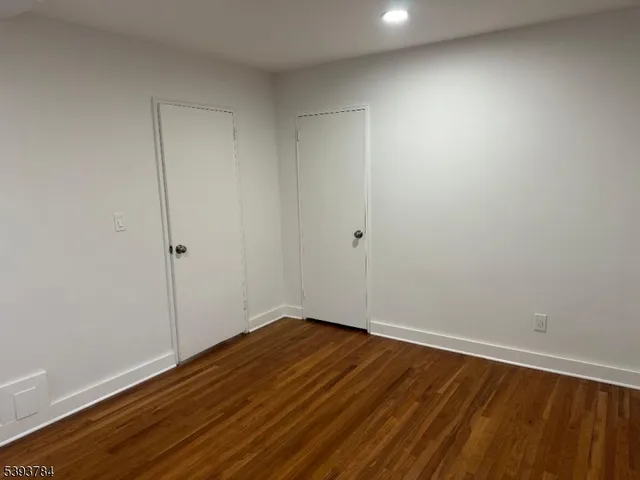 a view of room with wooden floor