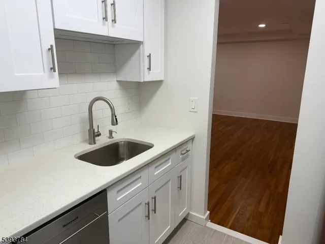 a kitchen with a sink and cabinets