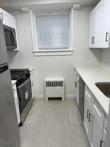 a kitchen with a sink a stove and cabinets