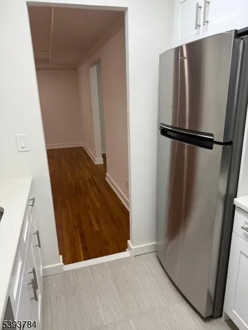 a view of a kitchen with a refrigerator