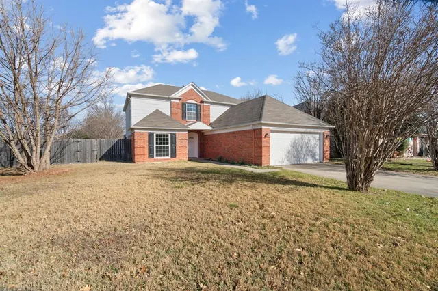 a front view of a house with a yard covered in snow