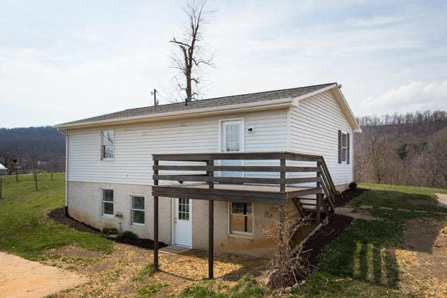 19680 North Mountain Road Timberville, VA 22853 - Photo 29 of 34 Convenient stairs lead from the deck to the side yard.