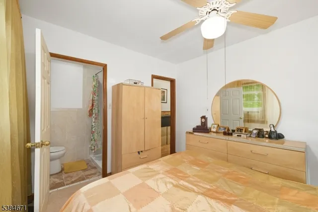 a bedroom with a bed and ceiling fan