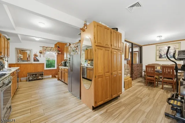 a view of a livingroom with furniture and a refrigerator