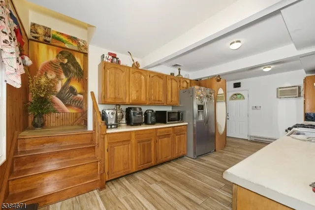 a kitchen with granite countertop a refrigerator and a stove top oven