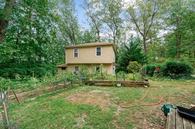 a brick house with lots of trees in the background