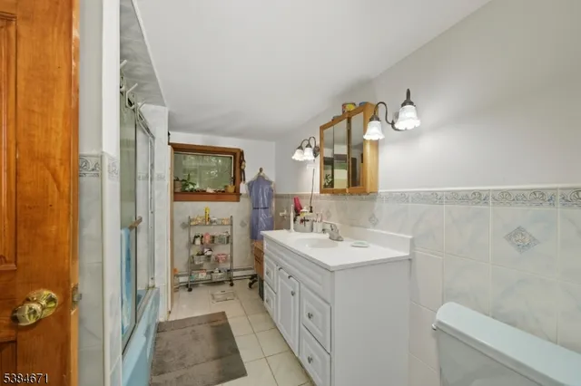 a spacious bathroom with a double vanity sink toilet and shower