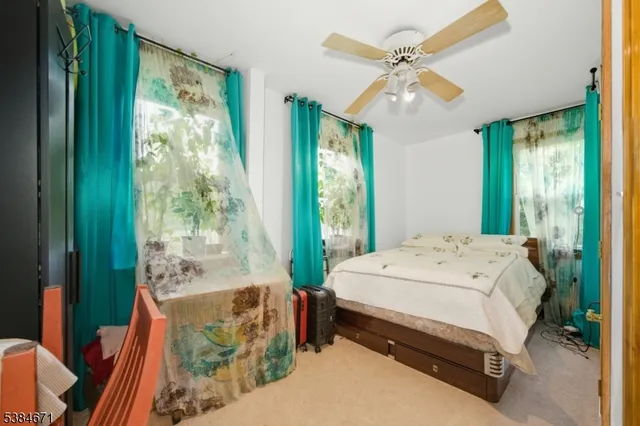 a spacious bedroom with a bed and a chandelier