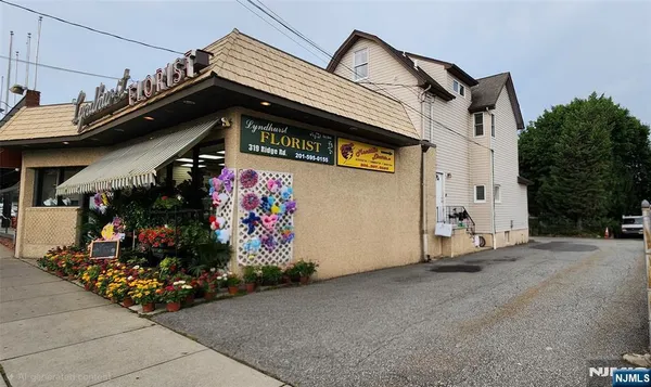 a view of a street with potted plants