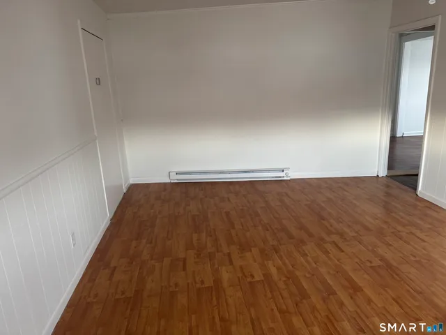 a view of room with wooden floor