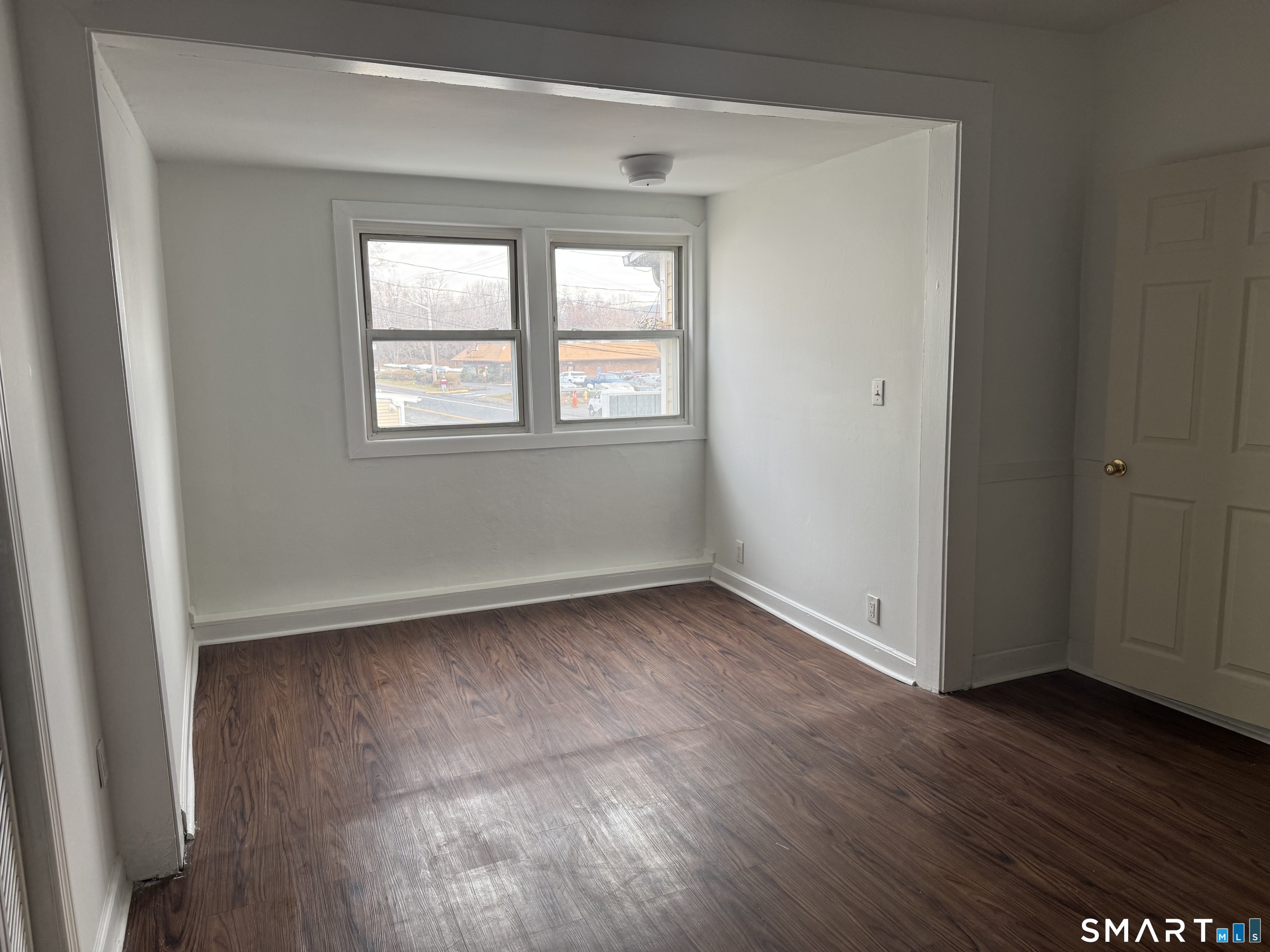 47 Pershing Drive, Unit 1 Ansonia, CT 06401 - Photo 13 of 21 an empty room with wooden floor and windows