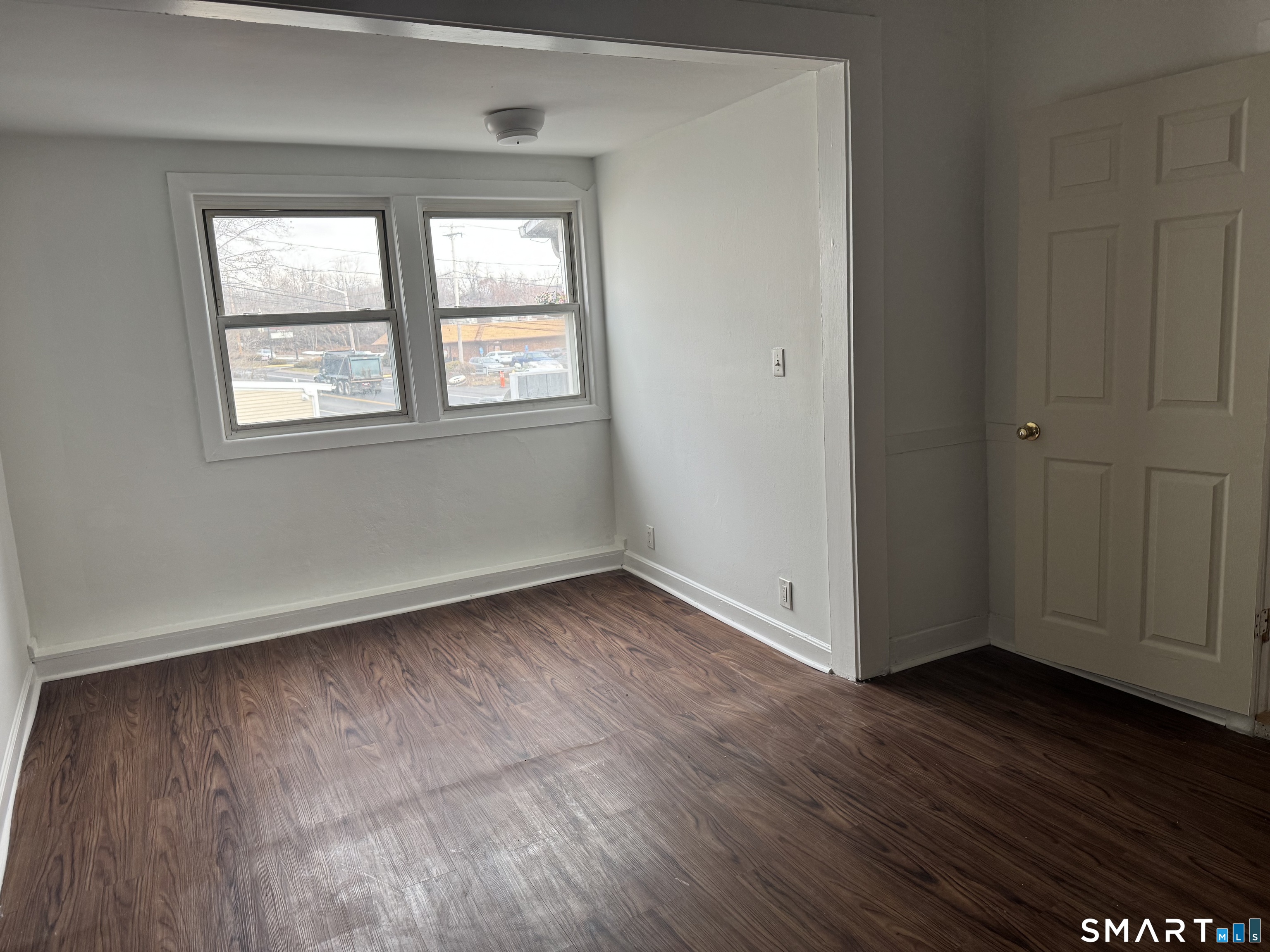 47 Pershing Drive, Unit 1 Ansonia, CT 06401 - Photo 15 of 21 an empty room with wooden floor and windows