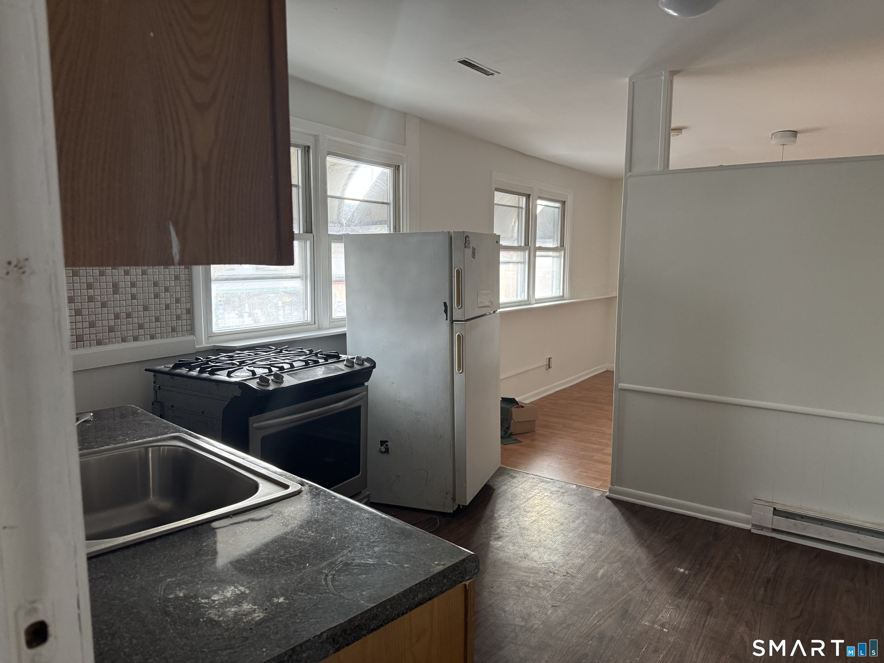 47 Pershing Drive, Unit 1 Ansonia, CT 06401 - Photo 7 of 21 a kitchen with granite countertop a refrigerator stove and sink