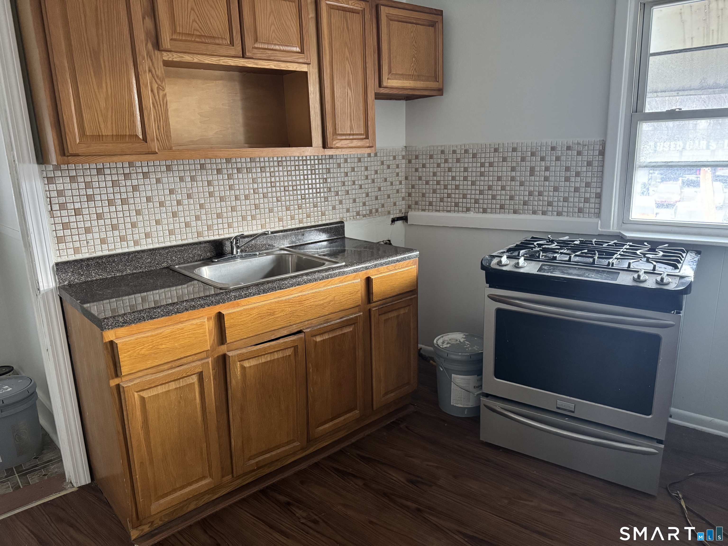 47 Pershing Drive, Unit 1 Ansonia, CT 06401 - Photo 9 of 21 a kitchen with stainless steel appliances granite countertop a stove a sink and a microwave
