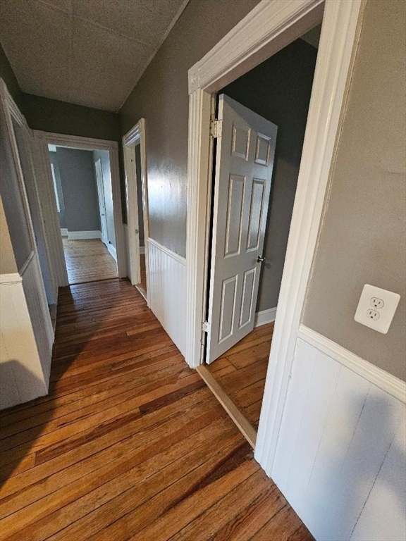 762 Globe Street, Unit 2 Fall River, MA 02724 - Photo 10 of 20 a view of a hallway with wooden floor and staircase