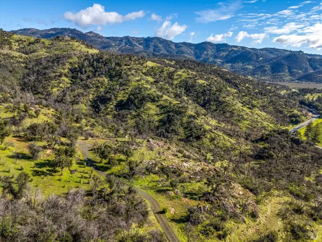 a view of a field with mountains in the background
