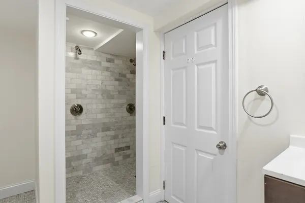 a bathroom with a glass shower door
