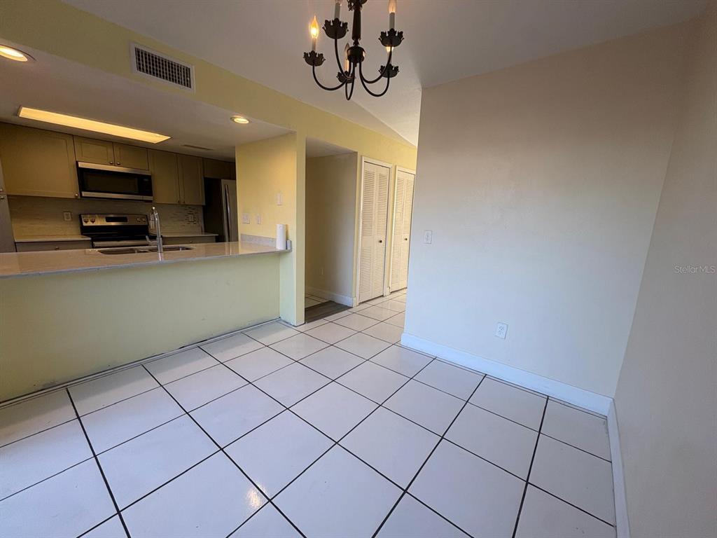 4033 Henley Road, Unit 1707 Orlando, FL 32839 - Photo 27 of 66 a view of a kitchen with microwave and cabinets