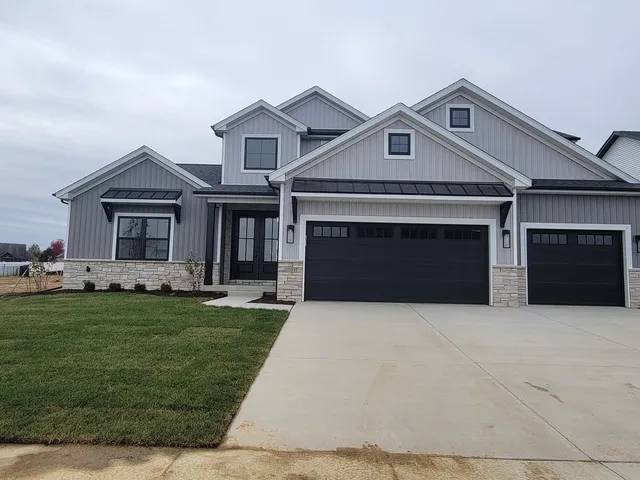 a front view of a house with a garden and yard