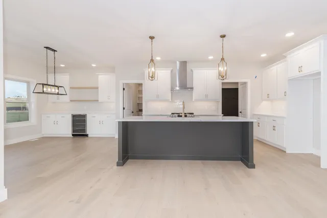 a view of kitchen with kitchen island a sink stainless steel appliances and cabinets