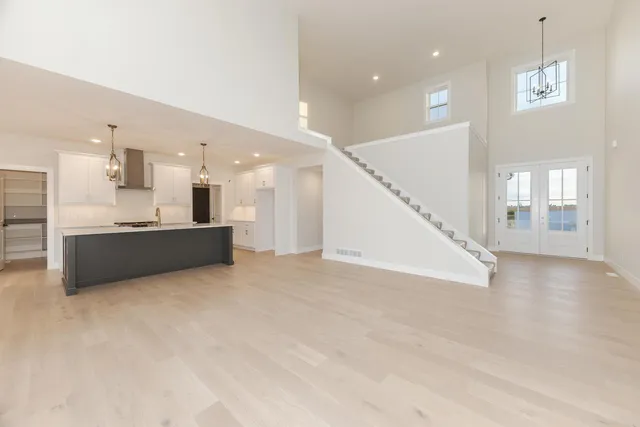 a view of a kitchen with a sink and a large window