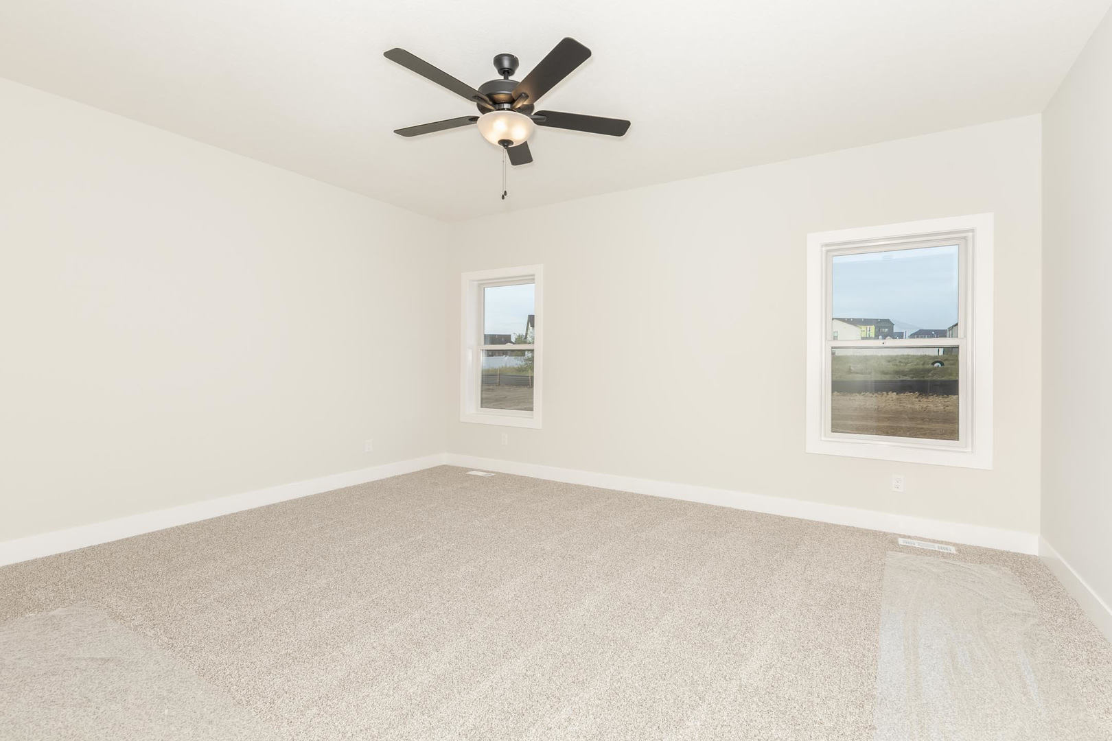 1009 Mount Carmel Road Bloomington, IL 61705 - Photo 18 of 39 an empty room with a window and a ceiling fan