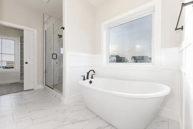 a white bath tub sitting next to a bathroom sink