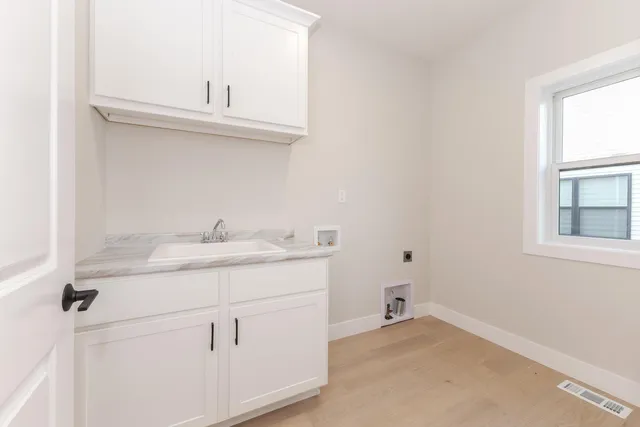 a bathroom with a sink and a window