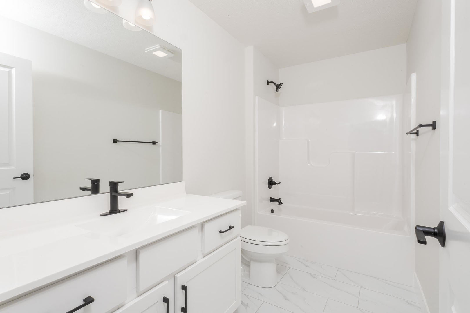 1009 Mount Carmel Road Bloomington, IL 61705 - Photo 31 of 39 a bathroom with a sink a toilet and shower