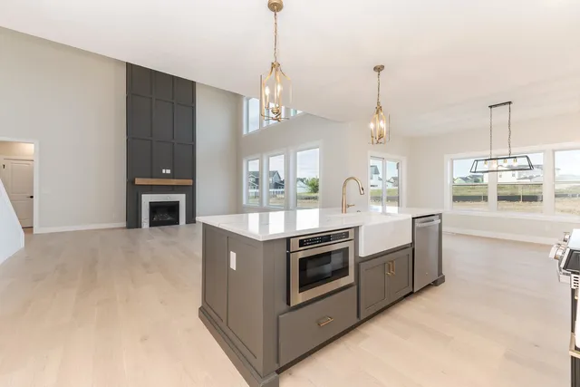 a kitchen with stainless steel appliances granite countertop a stove and a sink