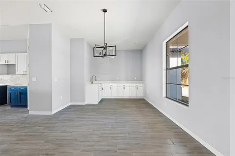 a view of an empty room with window and cabinet