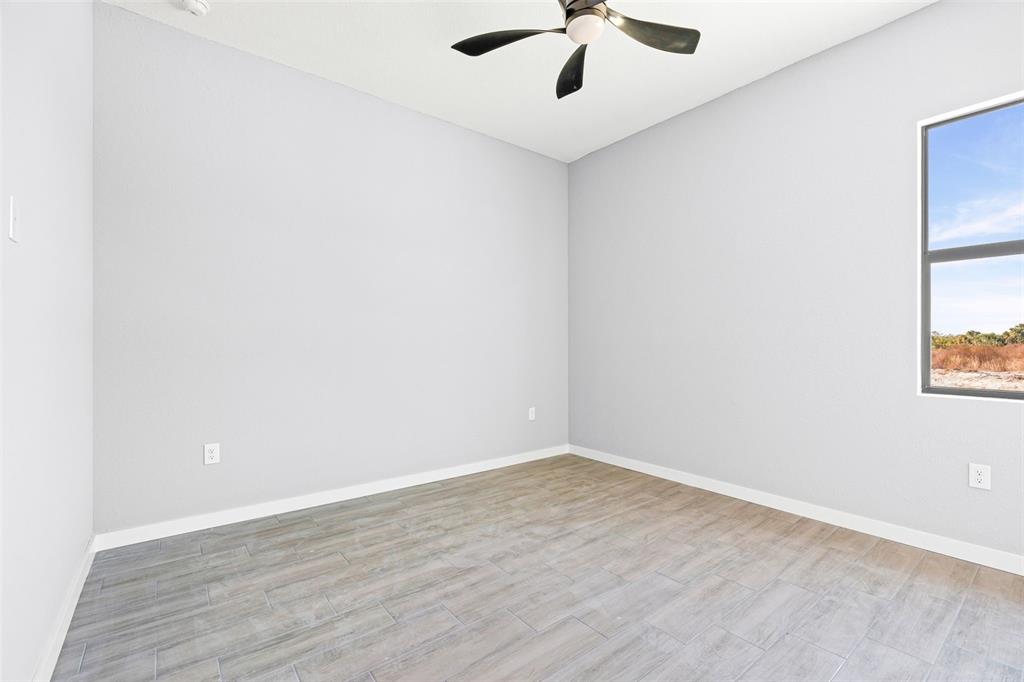 6137 Grove Boulevard Punta Gorda, FL 33982 - Photo 23 of 28 an empty room with a window and a fan