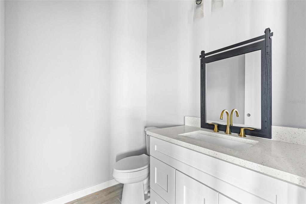 6137 Grove Boulevard Punta Gorda, FL 33982 - Photo 24 of 28 a bathroom with a toilet sink and mirror