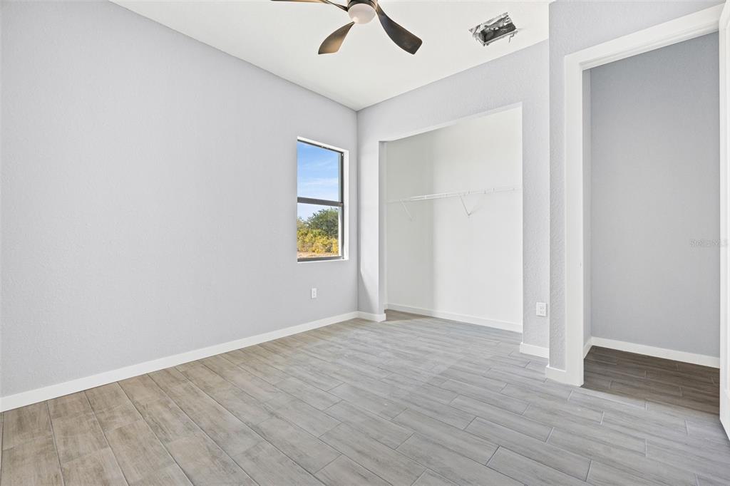 6137 Grove Boulevard Punta Gorda, FL 33982 - Photo 28 of 28 an empty room with a window and wooden floor