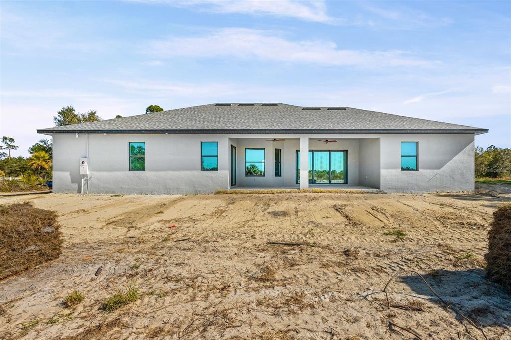 6137 Grove Boulevard Punta Gorda, FL 33982 - Photo 4 of 28 a front view of house with yard and ocean