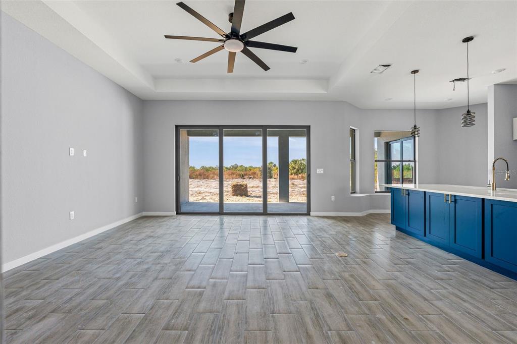 6137 Grove Boulevard Punta Gorda, FL 33982 - Photo 5 of 28 a view of an empty room with window and wooden floor