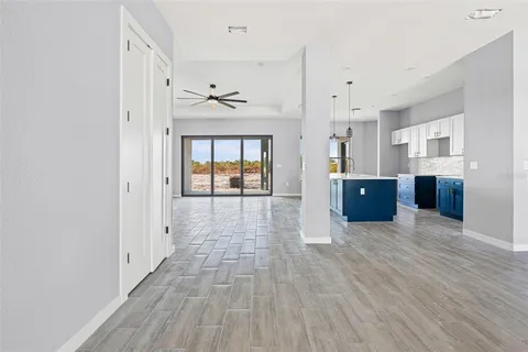 a view of empty room with wooden floor and windows