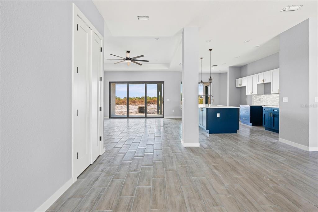6137 Grove Boulevard Punta Gorda, FL 33982 - Photo 9 of 28 a view of empty room with wooden floor and windows