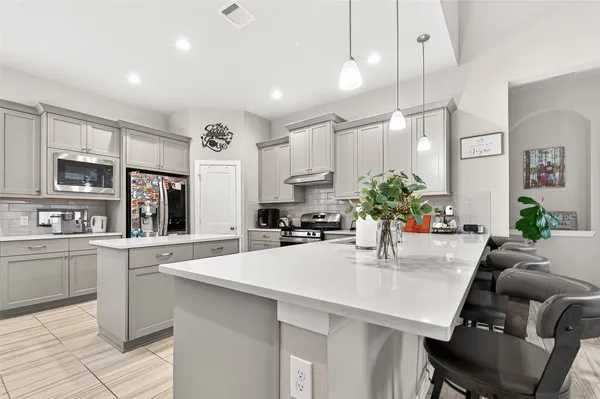 a kitchen with stainless steel appliances kitchen island granite countertop a sink and cabinets