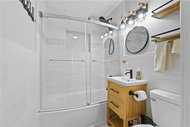 a bathroom with a mirror a sink and a mirror